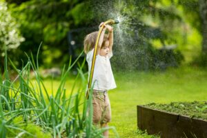 boy holding a garden hose